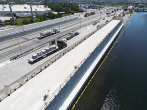 Aerial view of Mechanically Stabilized Earth (MSE) Wall 2 of 6 along the Miami Canal. The wall is part of Ramp B, which will connect eastbound Okeechobee Road to the southbound Palmetto Expressway. Construction is underway alongside active travel lanes.