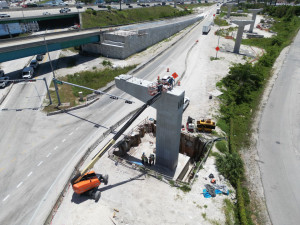 Aerial view of Mechanically Stabilized Earth (MSE) Wall 1 of 6, with bridge piers under construction along the southbound Palmetto Expressway on-ramp for Ramp B, which will provide a direct connect eastbound Okeechobee Road to southbound Palmetto Expressway.