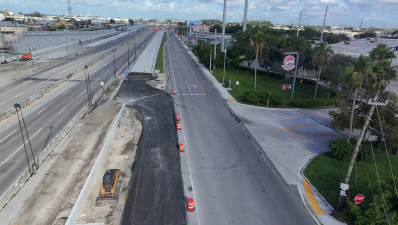 Aerial view of Frontage Road near Walmart’s driveway, showing the recently paved new access connecting westbound Frontage Road to westbound Okeechobee Road.